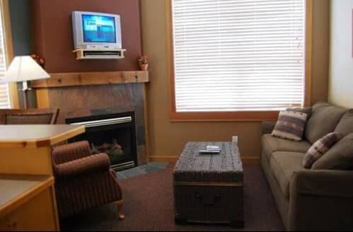 Living area with gas fireplace and wall-mounted TV over mantel