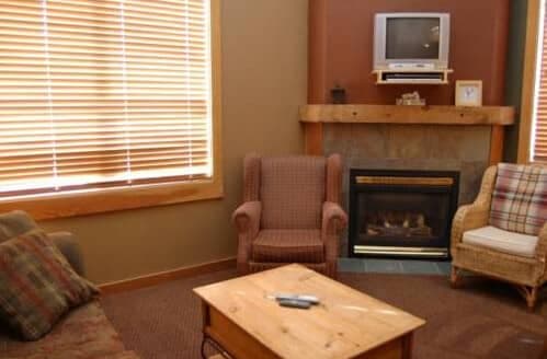 Living area with gas fireplace and wall-mounted TV