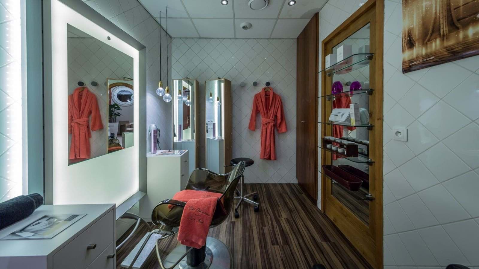 Private salon room with backlit mirror and styling chair
