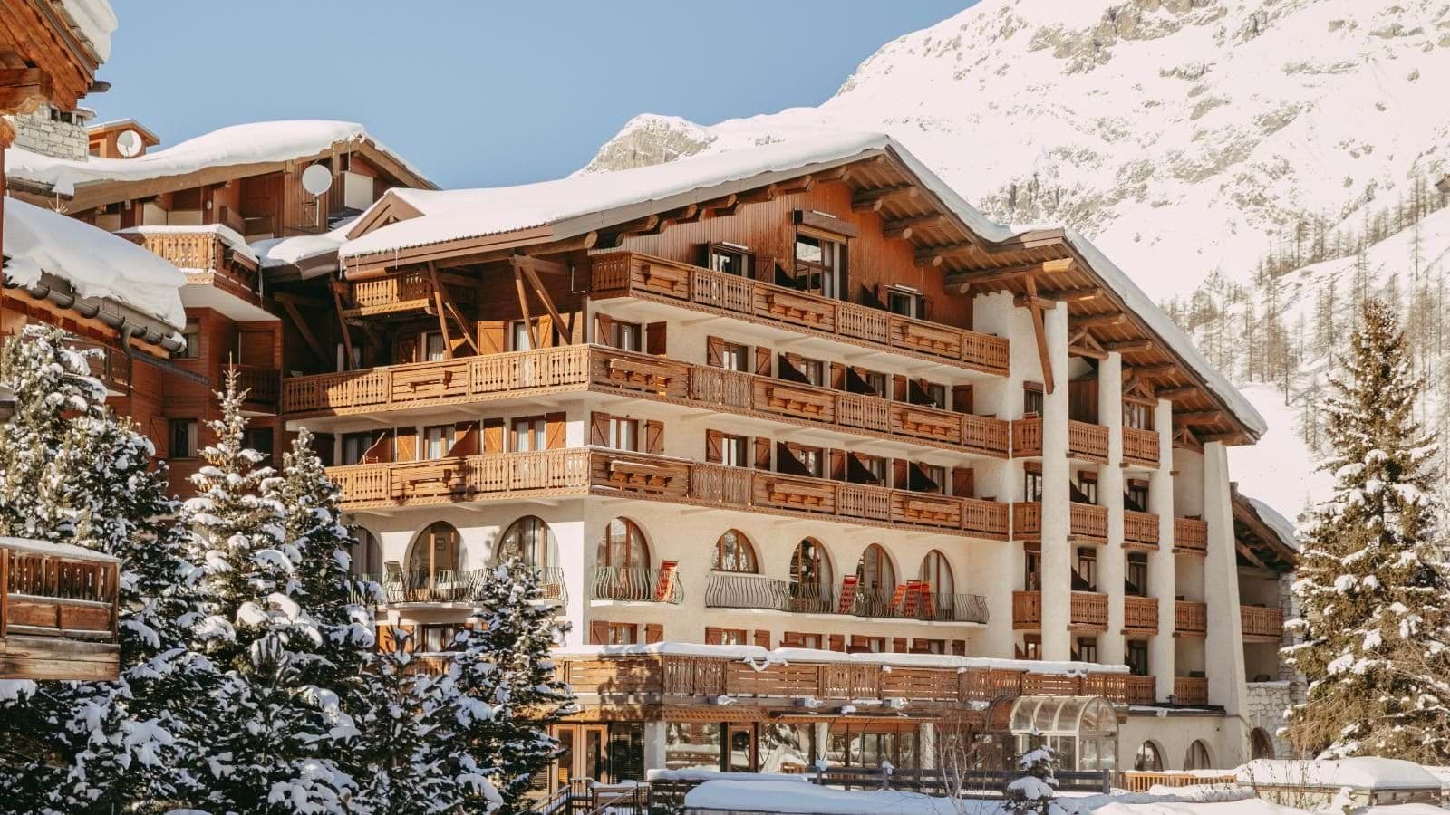Chalet exterior with private wooden balconies and mountain views