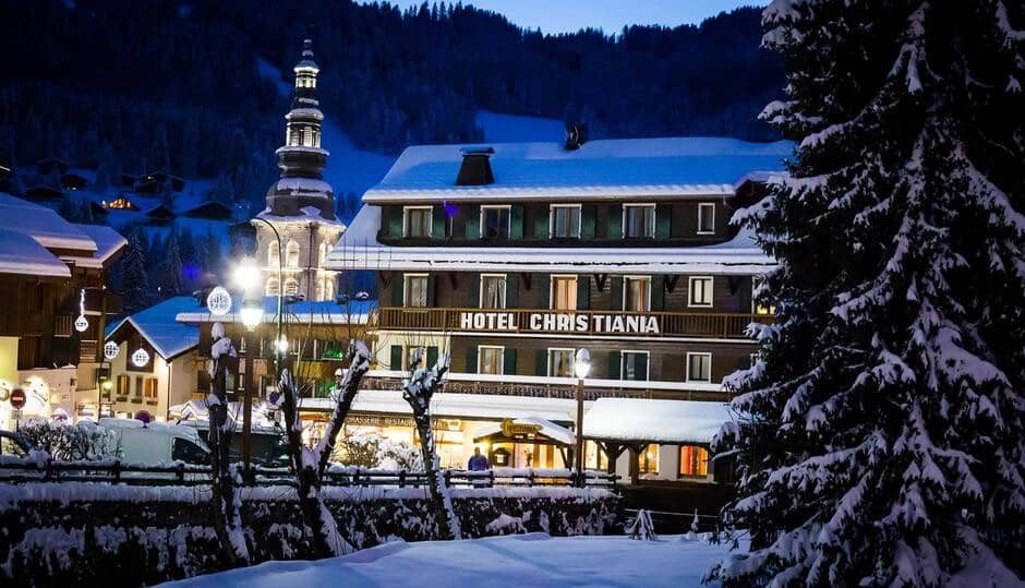 Hotel Christiania exterior in winter with village and church steeple views