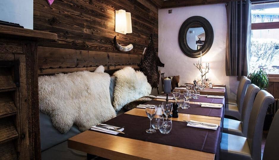 Dining area with booth seating and views of snow-covered outdoors