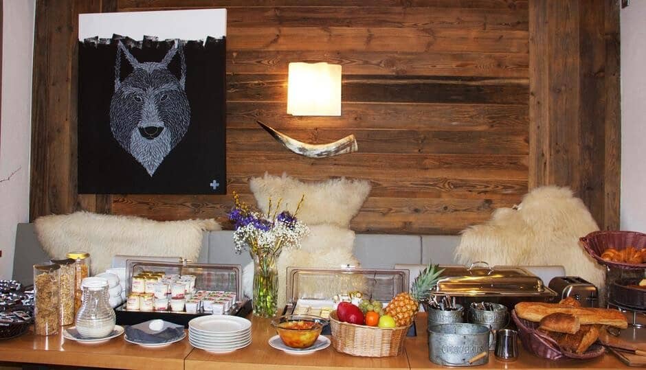 Dining area with breakfast buffet and banquette seating with sheepskin throws