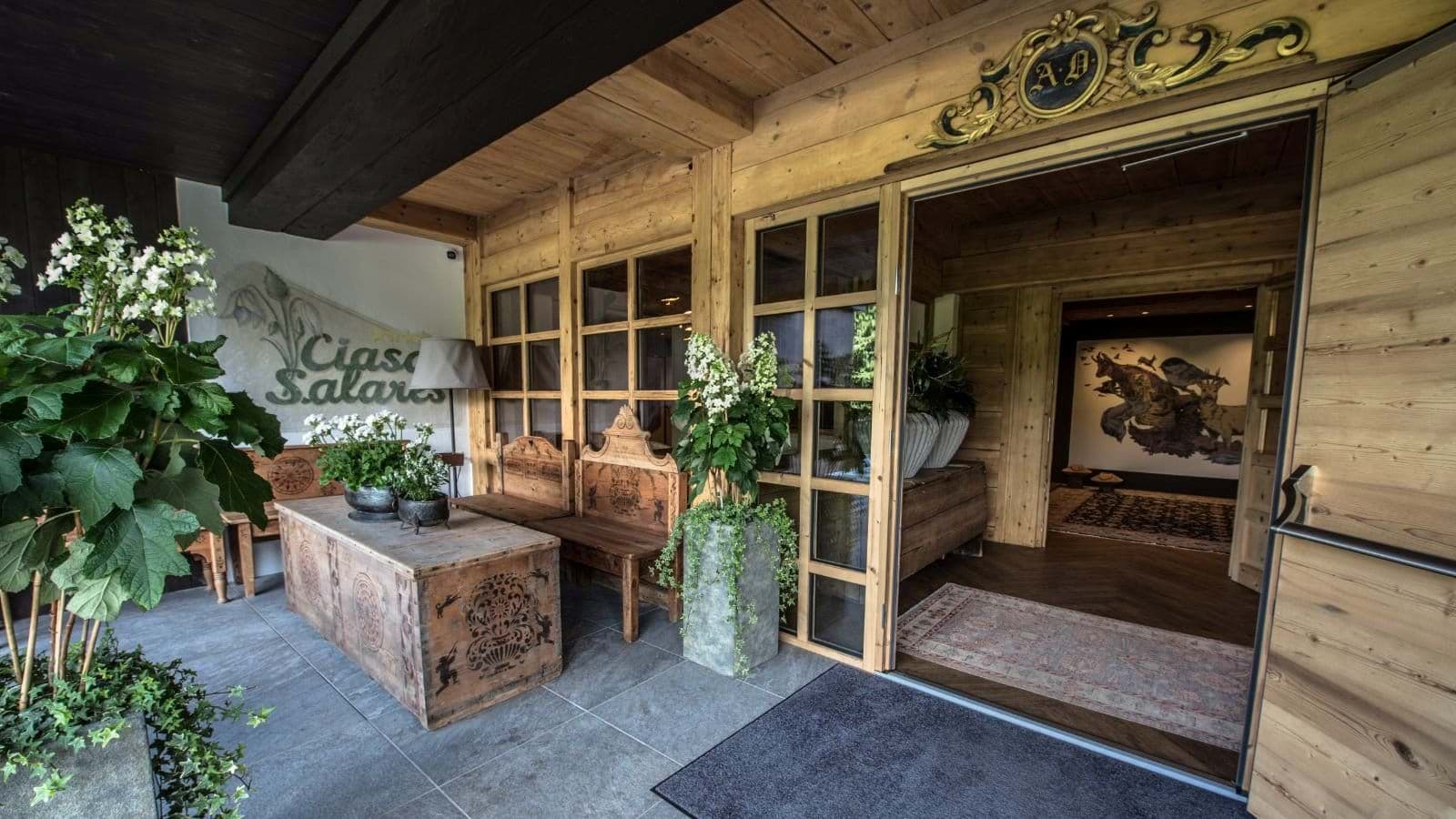 Covered entryway featuring traditional wood carvings and hand-painted antique chests