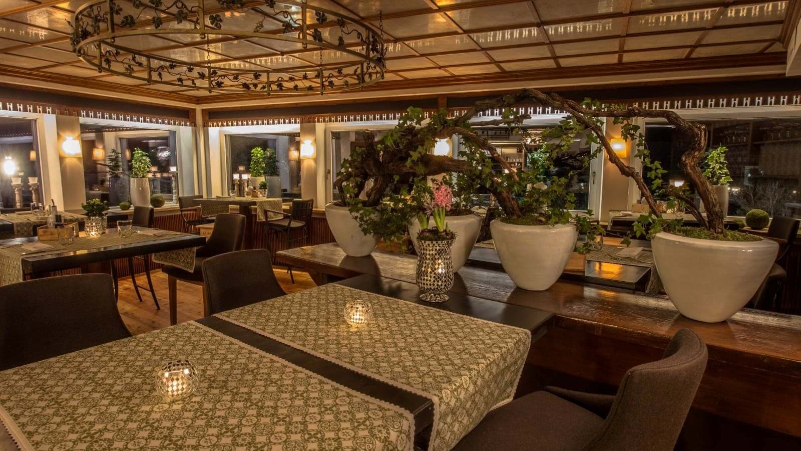 Dining area with booth and table seating; wood-paneled coffered ceiling