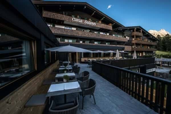 Outdoor dining terrace with mountain views and umbrella-shaded seating