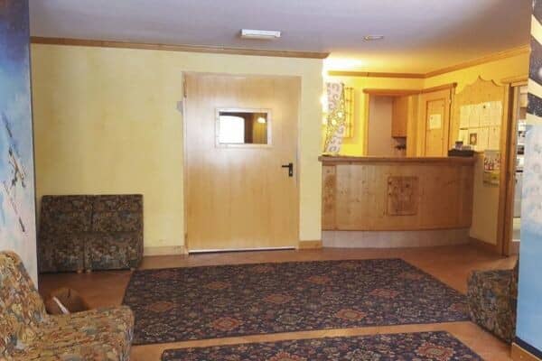 Reception area with wooden service desk and lounge seating