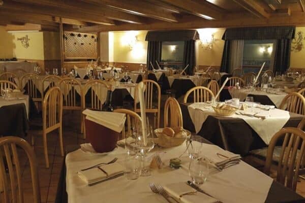 Shared dining room with timber-beamed ceiling and seating for large groups