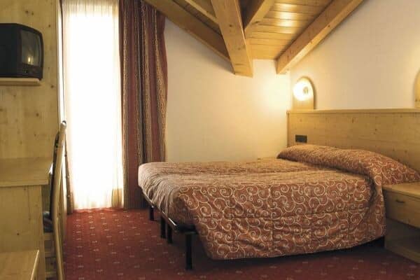 Guest bedroom with two twin beds pushed together and workspace desk