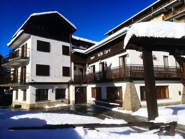 Hotel Villa Cervi exterior with private balconies and snow-cleared entrance