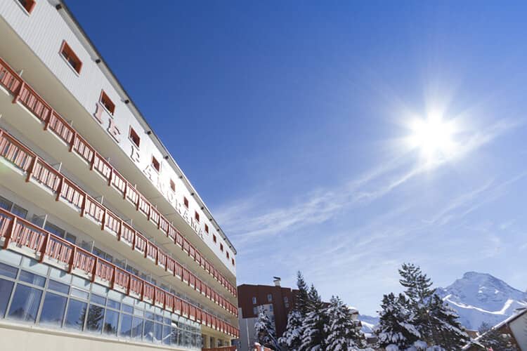 Hotel exterior featuring private balconies and south-facing mountain views