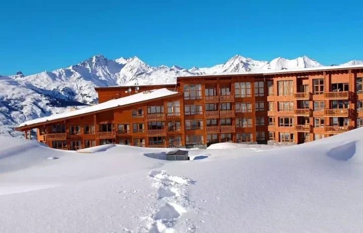 Ski-in/ski-out chalet exterior with private balconies and mountain views