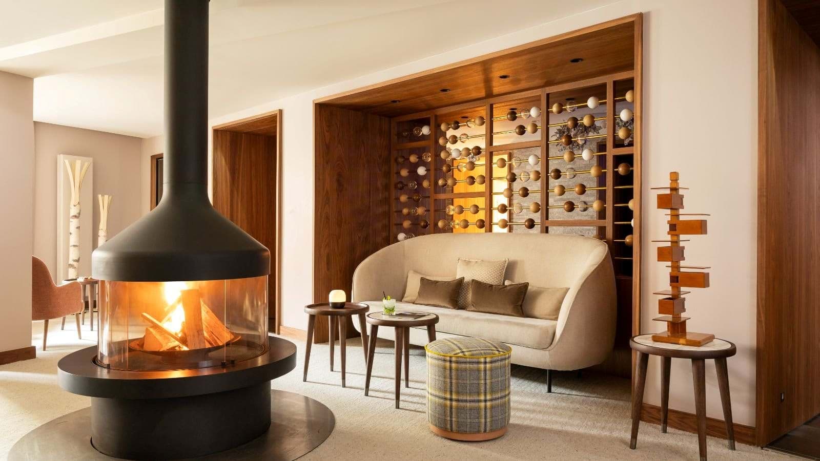 Lounge area with 360-degree wood-burning fireplace and curated wine display