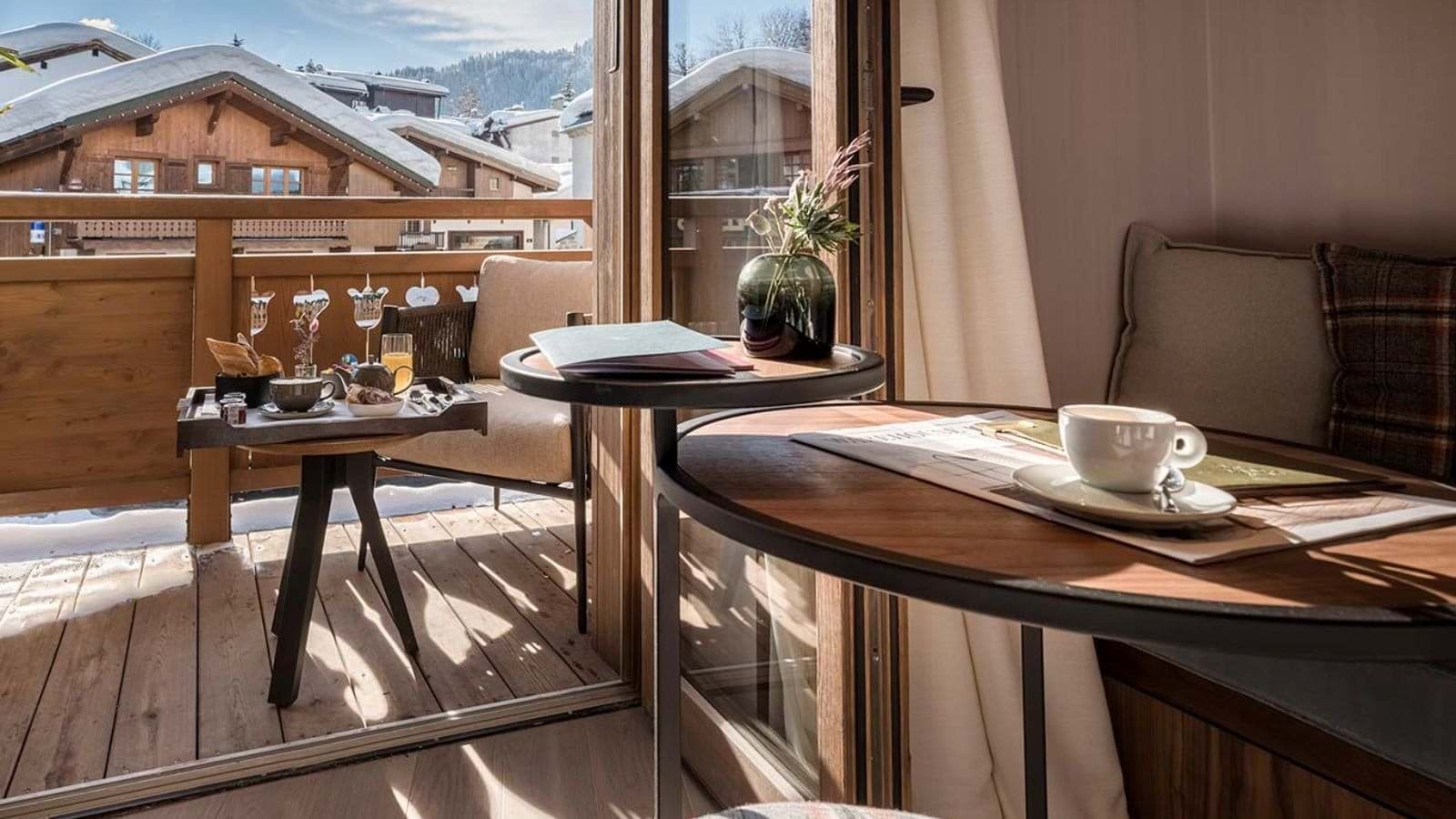 Private balcony and breakfast nook with snow-covered village views