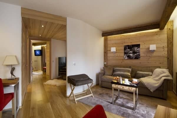 Sitting area with sleeper sofa and wood-paneled feature wall