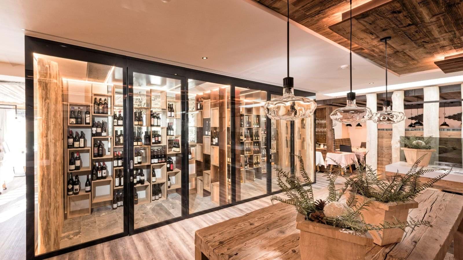 Temperature-controlled glass wine cellar adjacent to dining area
