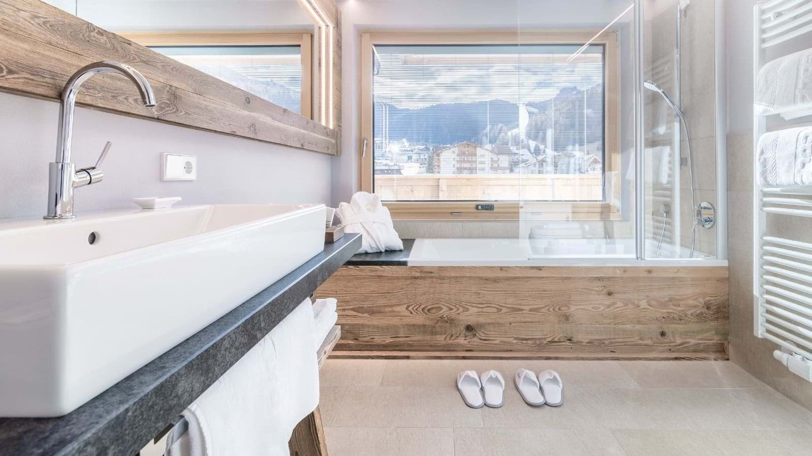 Bathroom with soaking tub, heated towel rail, and mountain views