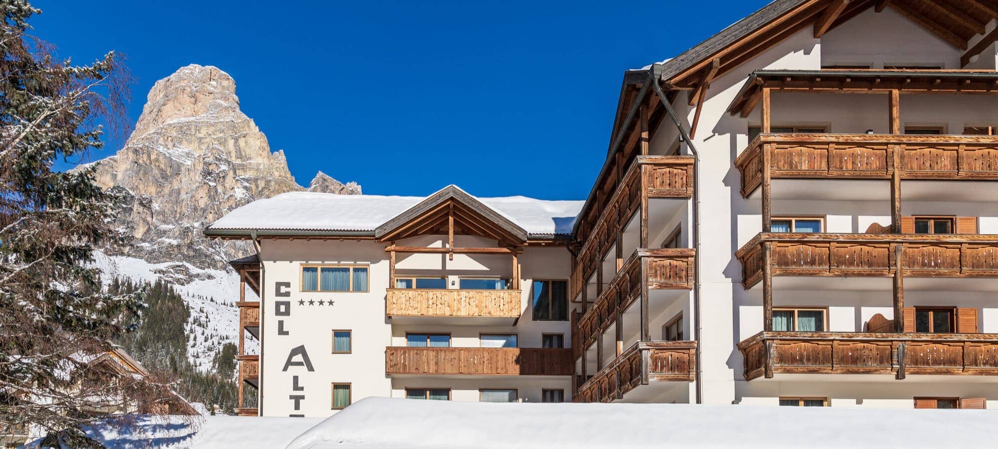 Chalet exterior with private balconies and Dolomite mountain views