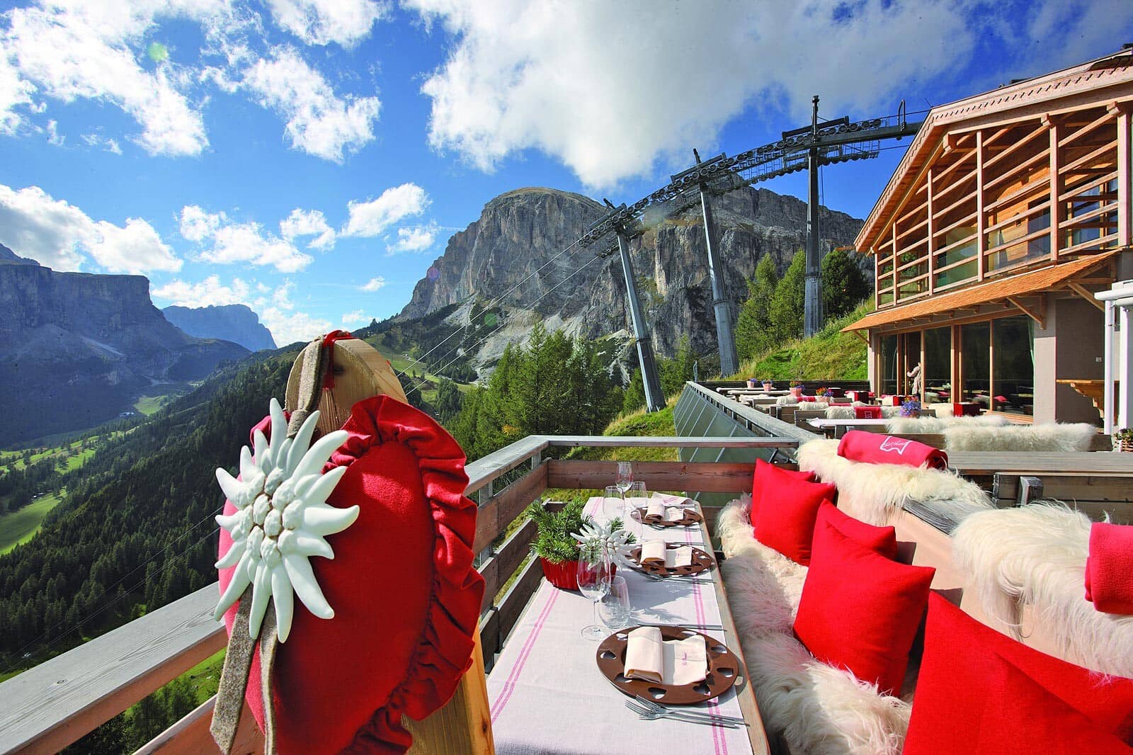 Dining terrace with fur seating and views of the nearby ski lift