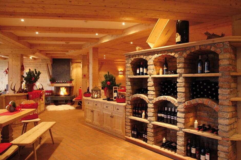 Wine cellar with brick shelving and wood-burning fireplace