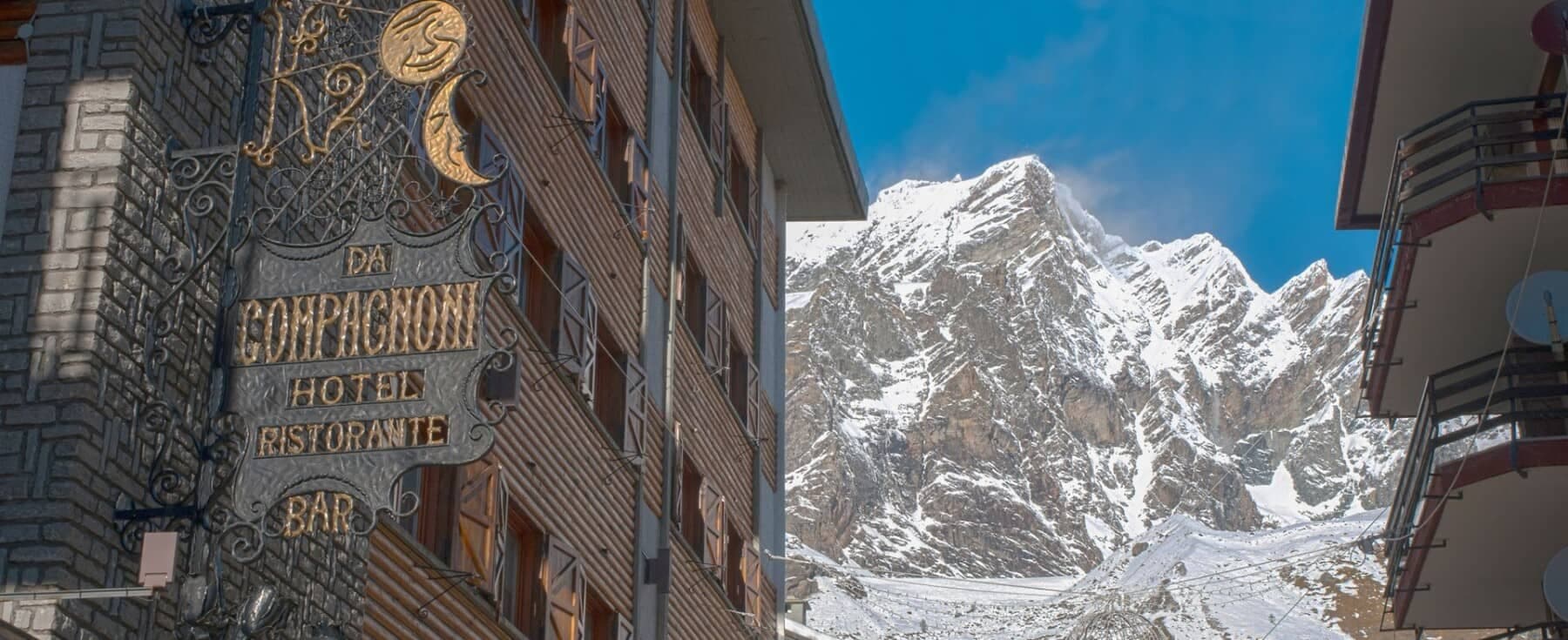 Hotel exterior with restaurant and bar; immediate access to alpine peaks