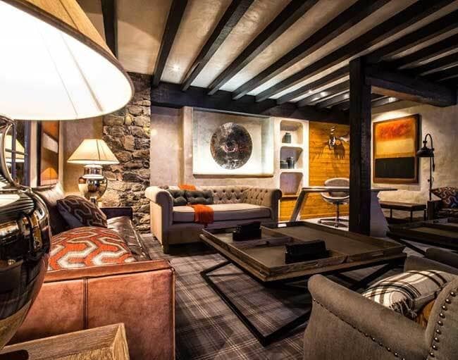 Lower-level lounge with exposed timber beams and dedicated workspace