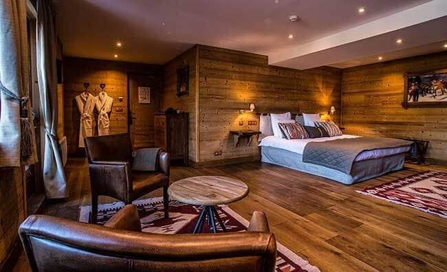 Primary bedroom with king bed and leather armchair seating area