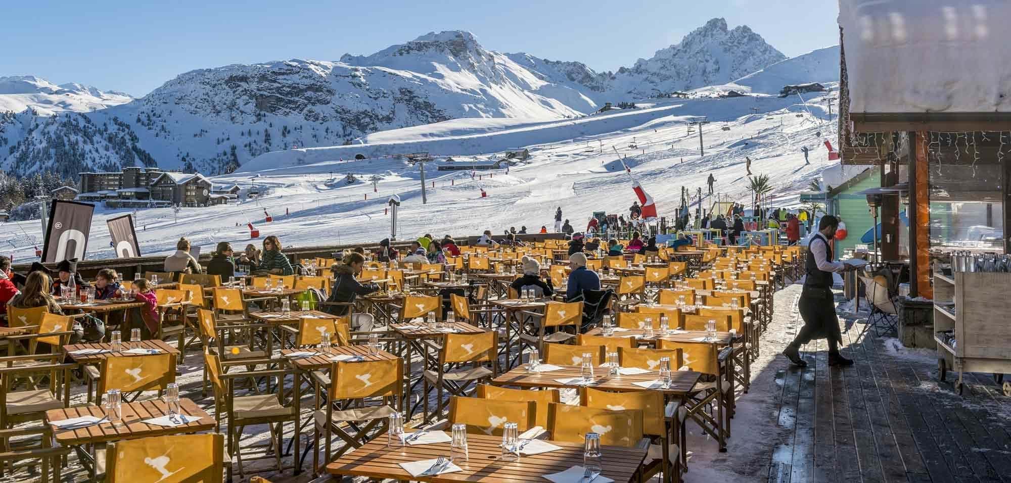 Ski-in dining terrace with slope views and seating for large groups