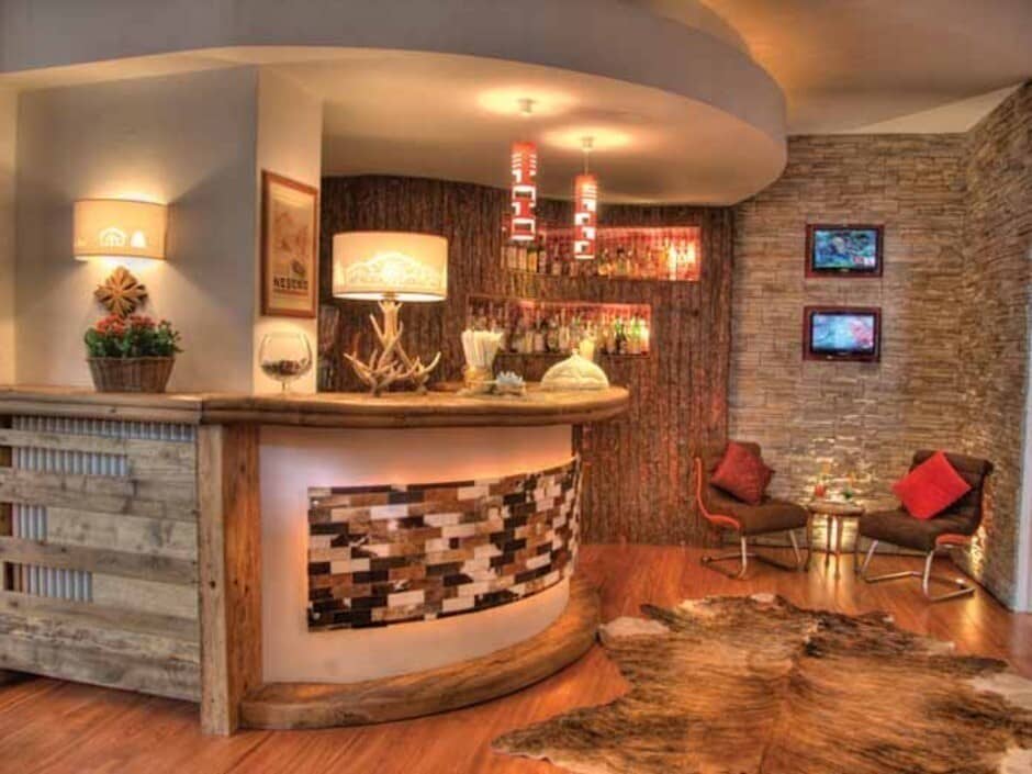 Lower level bar with backlit counter and dual-screen seating area