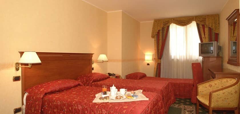 Guest bedroom with three twin beds and dedicated workstation