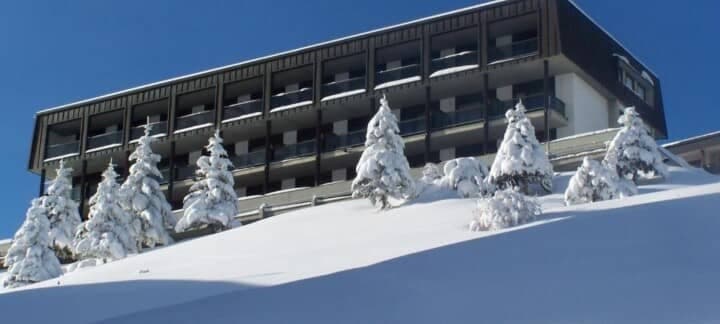 Ski-in/ski-out apartment complex with private balconies and snow-covered terrain