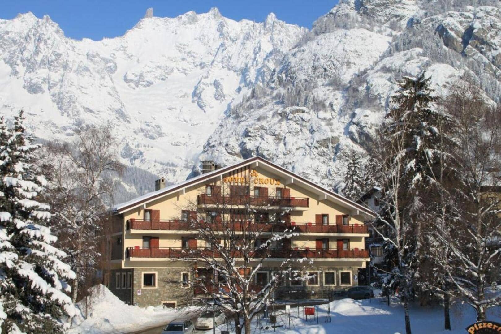 Exterior view featuring private balconies and snow-covered mountain backdrop