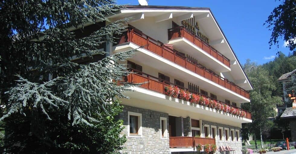 Multi-level lodge exterior with private wooden balconies and flower boxes