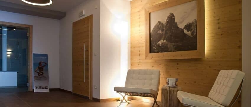 Spa waiting area with lounge seating and adjacent steam room or sauna