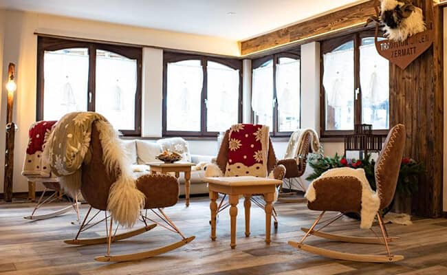 Lounge area with sheepskin-lined rocking chairs and timber accents