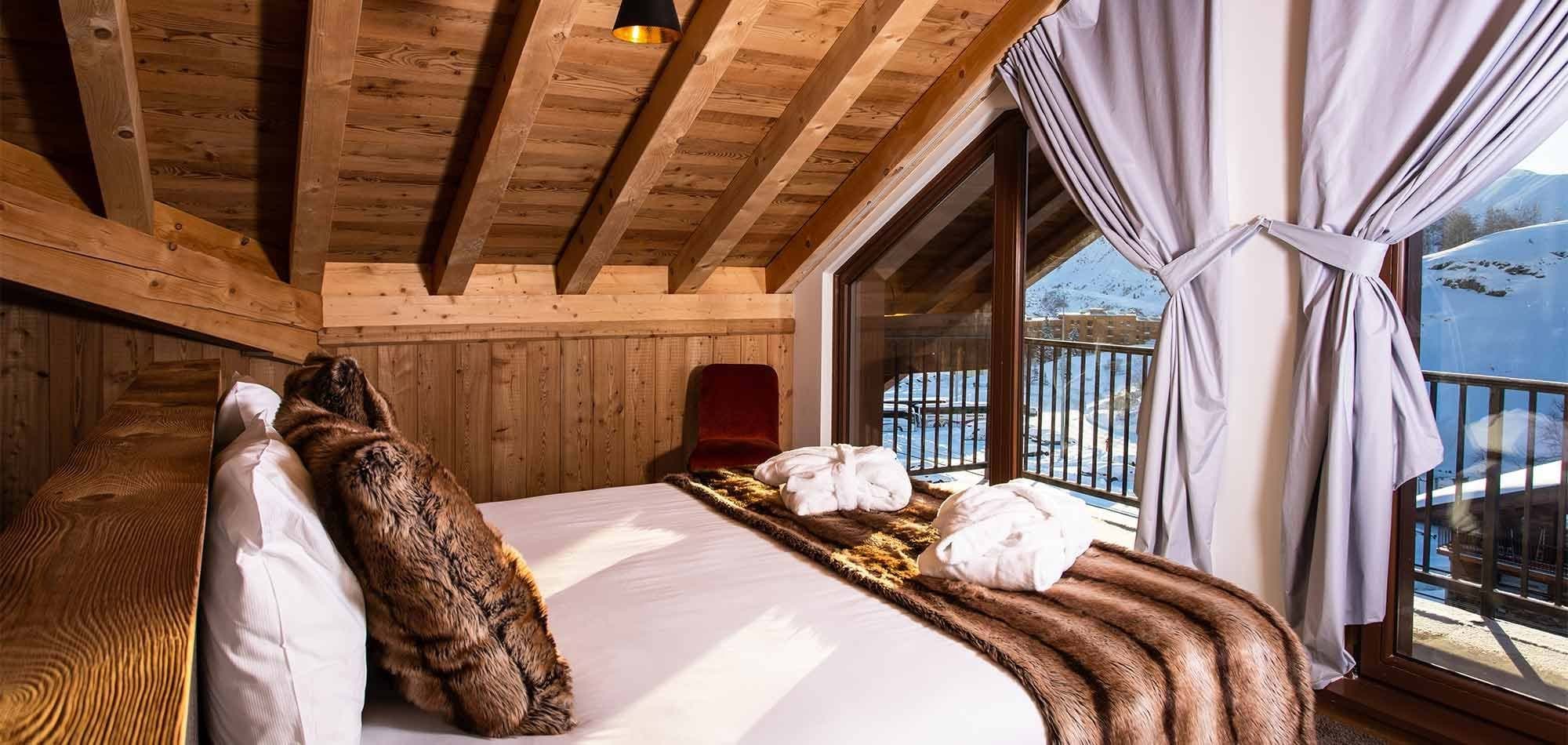Loft bedroom with private balcony and snowy mountain views