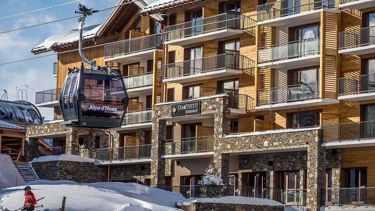 Ski-in/ski-out exterior beside Alpe d'Huez gondola and onsite restaurant