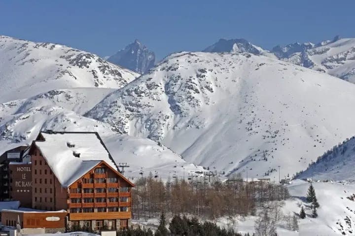 Ski-in/ski-out hotel view with direct access to chairlifts and mountain peaks