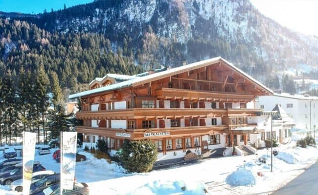 Alpine lodge exterior with private balconies and mountain views