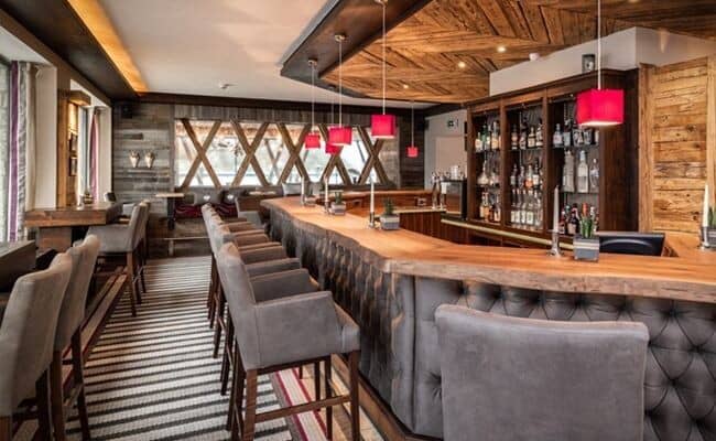 Bar with live-edge wood counters and tufted leather seating