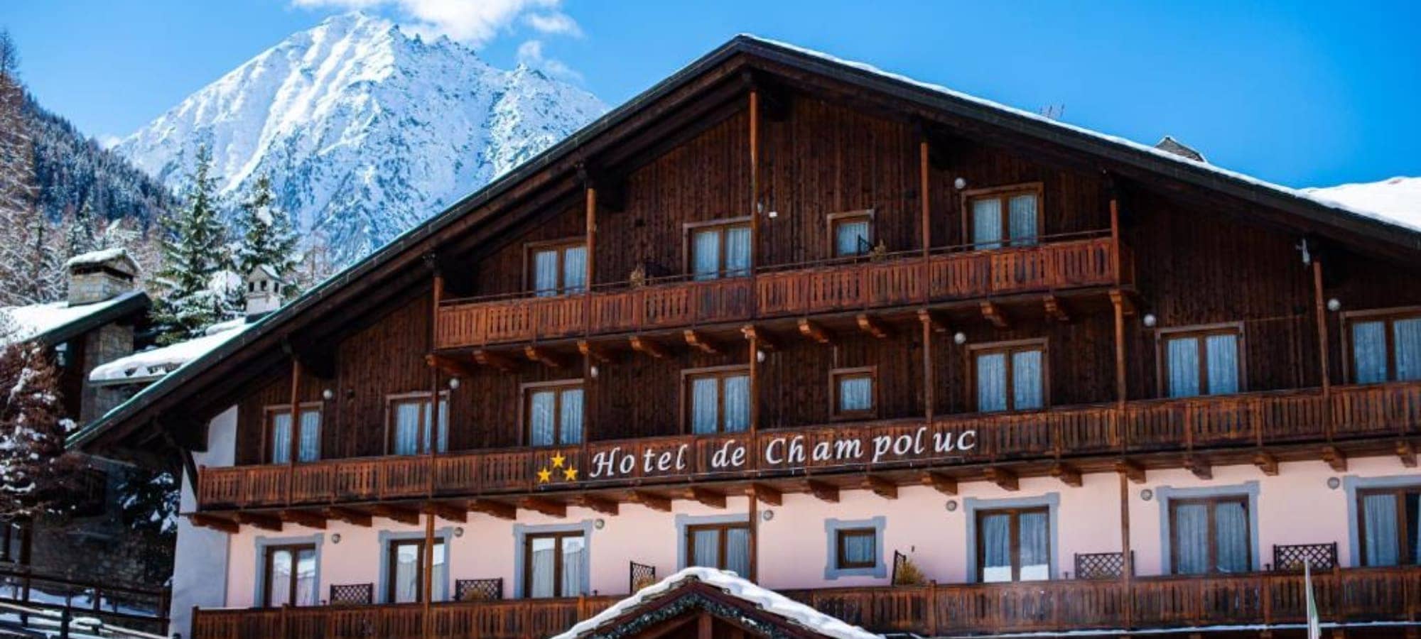 Chalet exterior with private balconies and snow-capped mountain views