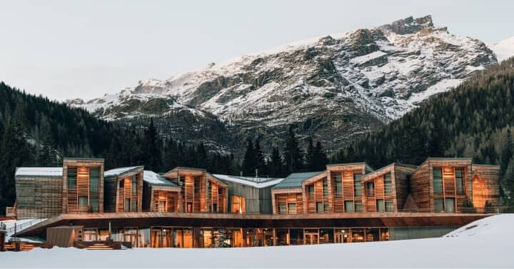 Ski-in, ski-out timber lodge at base of snow-capped mountains
