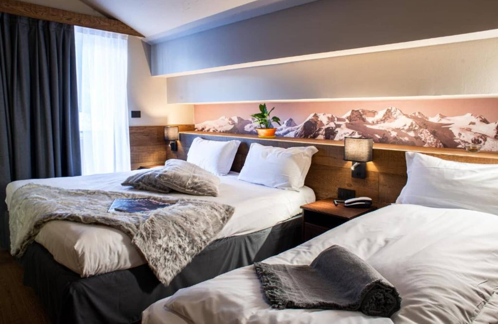 Guest bedroom with two twin beds and integrated reading lights