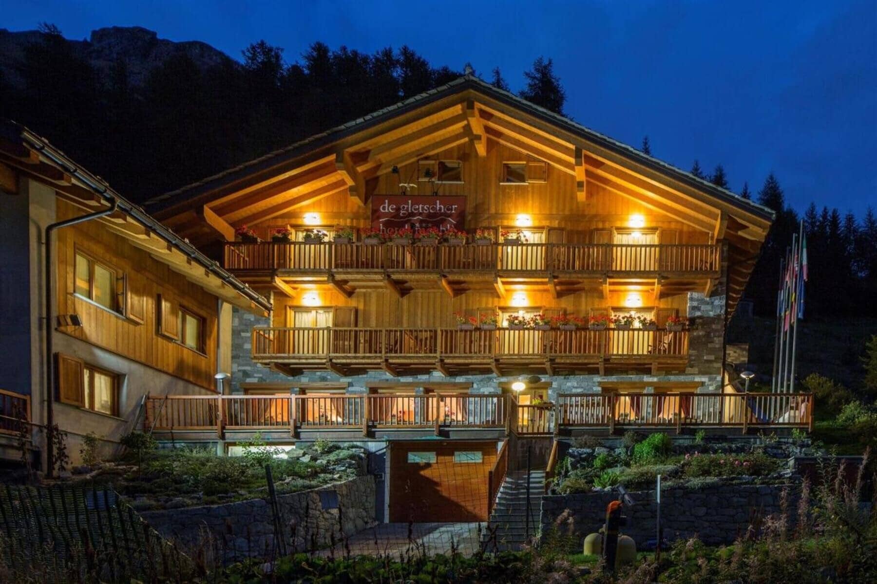 Chalet exterior with three levels of wraparound balconies and timber facade