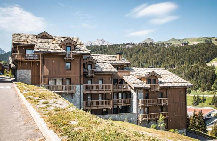 Chalet exterior with multiple private balconies and mountain views