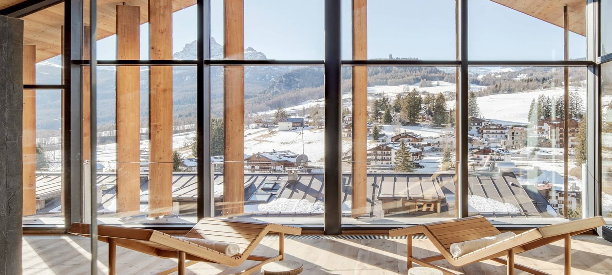 Sunroom lounge with floor-to-ceiling windows and mountain valley views