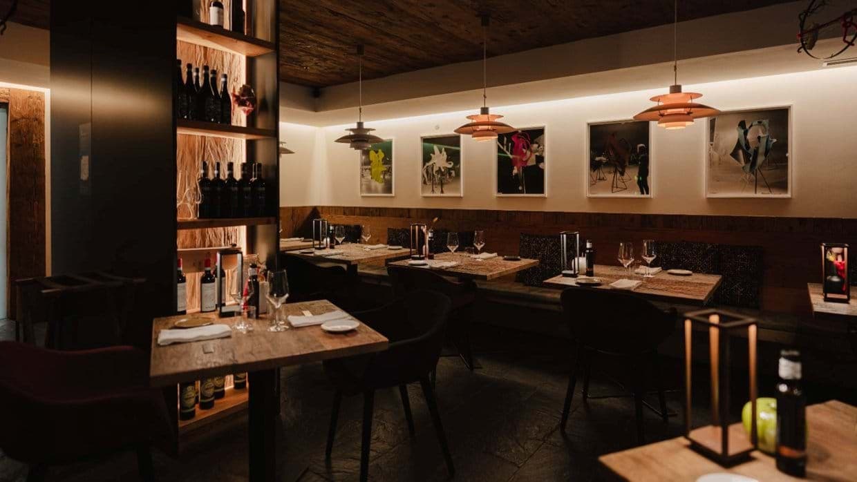 Dining area with banquette seating and wine display shelves
