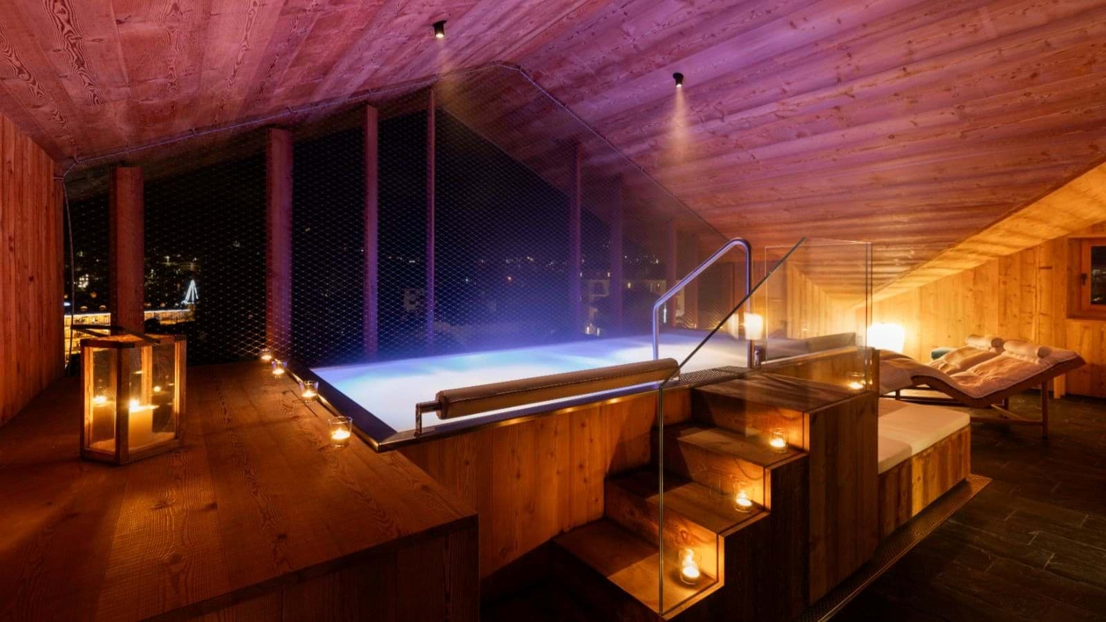 Indoor pool with wood-paneled ceiling and panoramic evening views
