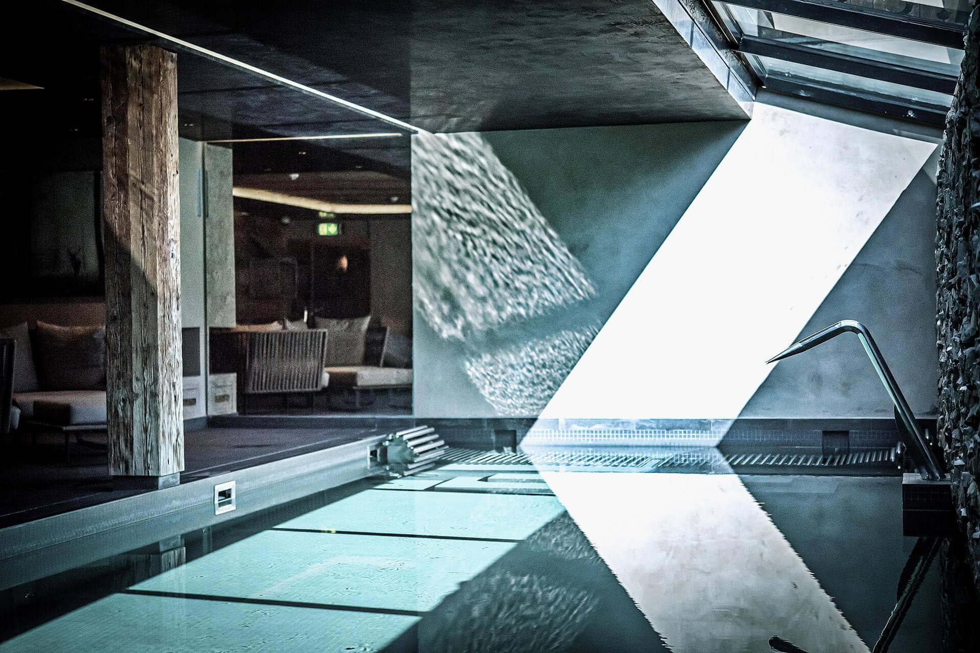 Indoor pool with swan neck waterfall and natural skylight ventilation
