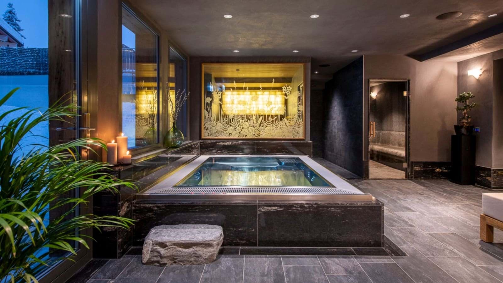 Indoor pool and spa area with adjacent steam room